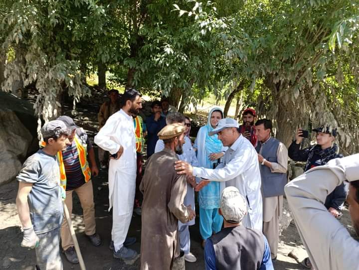 President Ismaili Council Upper Chitral, Imtiaz Alam, listens to a flood victim in Sorech