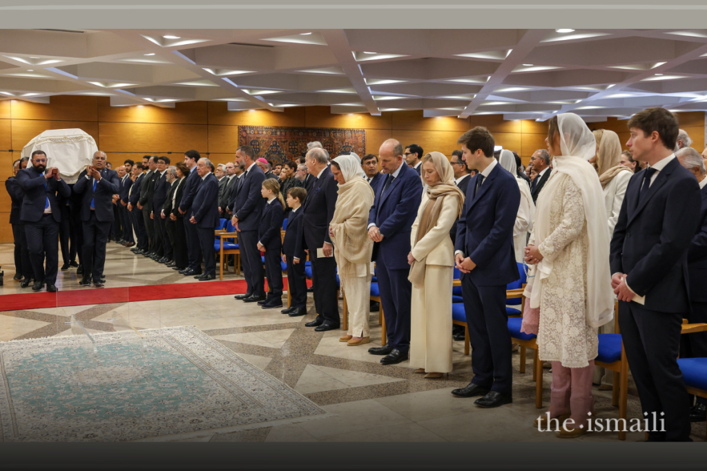 Ismaili Volunteers carry the janaza (casket) of Mawlana Shah Karim into the funeral hall.