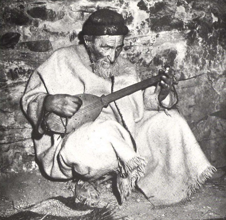 A former Kafir still singing hymns to goddeses in 1953 playing Urba guitar by Jones Schuyler in his book Nuristan