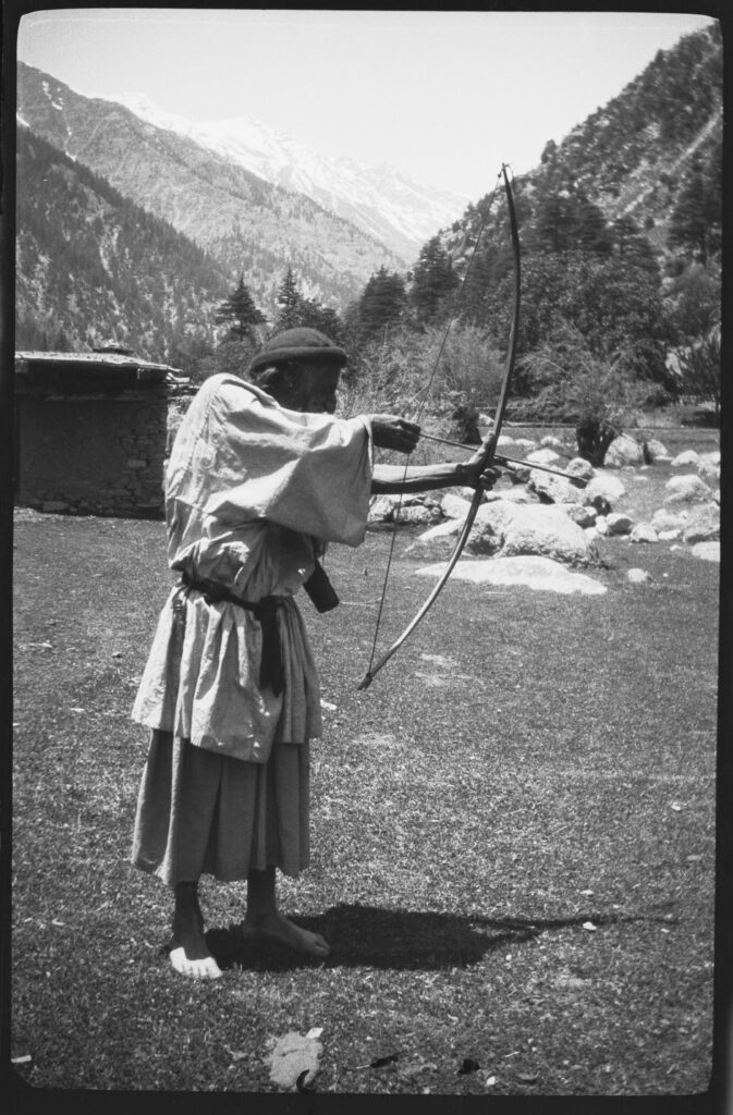 Bumboret Valley, Chitral, The Kati village headman Baghashai showing his skill as an archer in 1929 picture by Georg Morgenstierne